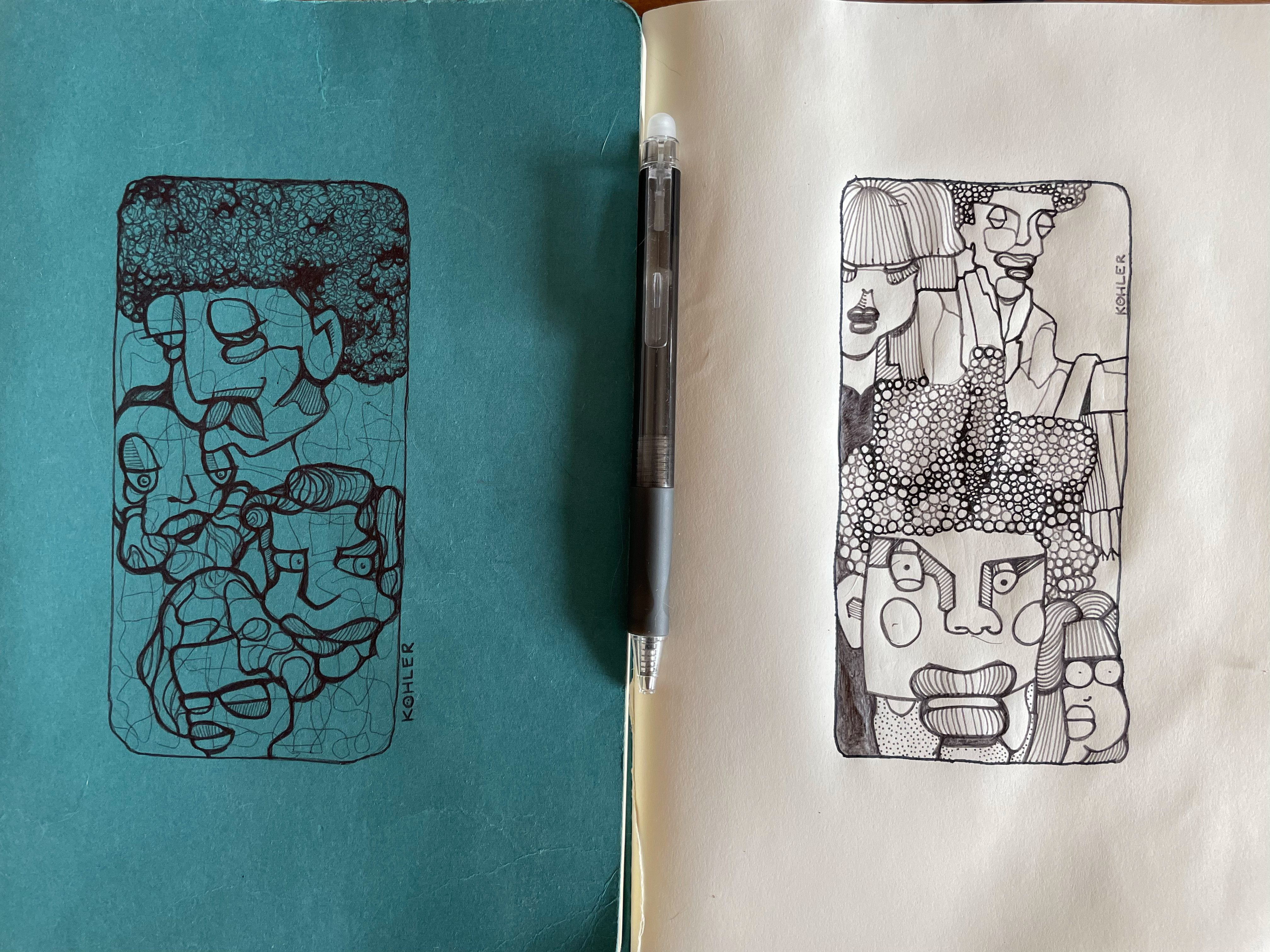 Two sketches of abstract faces in notebook
